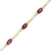 Zales Oval Garnet And Diamond Accent Bracelet In Sterling Silver And 10K Gold Plate - 7.25" Bracelets