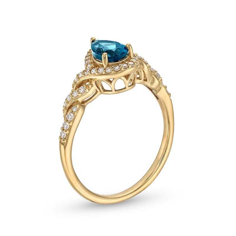 Zales Pear-Shaped London Blue Topaz And 1/5 Ct. T.W. Diamond Frame Twist Shank Ring In 10K Gold Rings