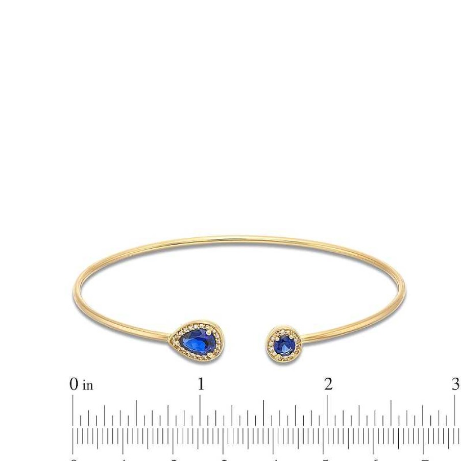 Zales Pear-Shaped And Round Blue Lab-Created Sapphire With 1/8 Ct. T.W. Diamond Open Flex Bangle In 10K Gold Bracelets