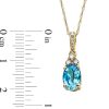 Zales Oval Swiss Blue Topaz And 1/15 Ct. T.W. Diamond Pendant In 10K Gold Necklaces