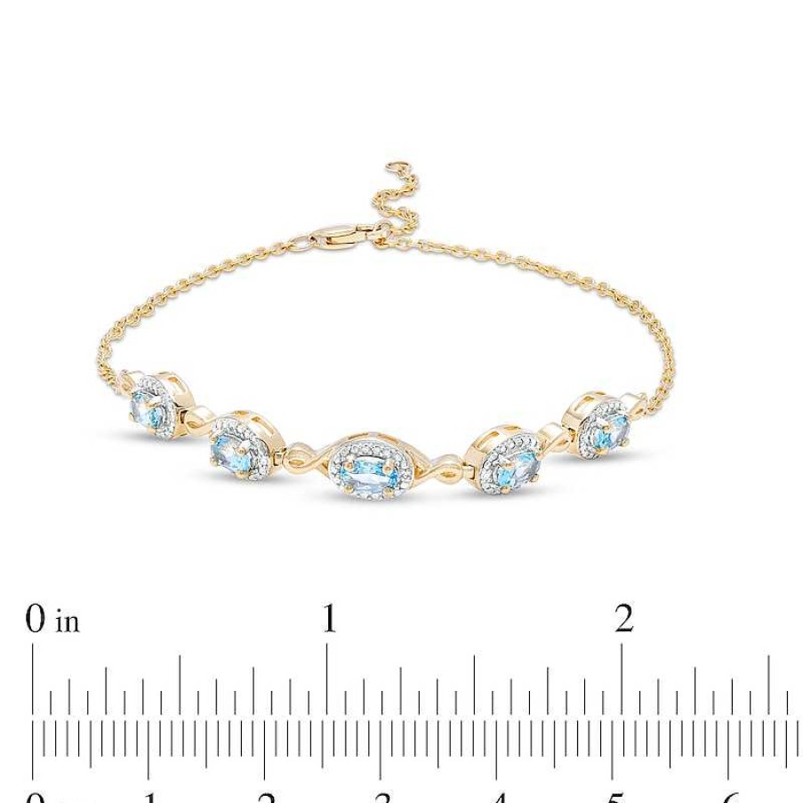 Zales Oval Swiss Blue Topaz And Diamond Accent Twist Five Stone Bracelet In 10K Gold 8.0" Bracelets