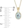 Zales Oval Swiss Blue Topaz And 1/15 Ct. T.W. Diamond Frame Pendant In 10K Gold Necklaces