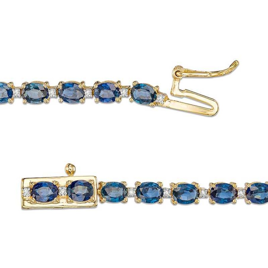 Zales Oval Blue Sapphire And 1/6 Ct. T.W. Diamond Alternating Line Bracelet In 10K Gold Bracelets