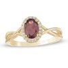 Zales Oval Garnet And 1/15 Ct. T.W. Diamond Frame Twist Shank Ring In 10K Gold Rings