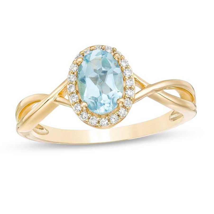 Zales Oval Swiss Blue Topaz And 1/15 Ct. T.W. Diamond Frame Twist Shank Ring In 10K Gold Rings