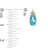 Zales Oval Swiss Blue Topaz And 1/10 Ct. T.W. Diamond Stud Earrings In 10K Gold Earrings