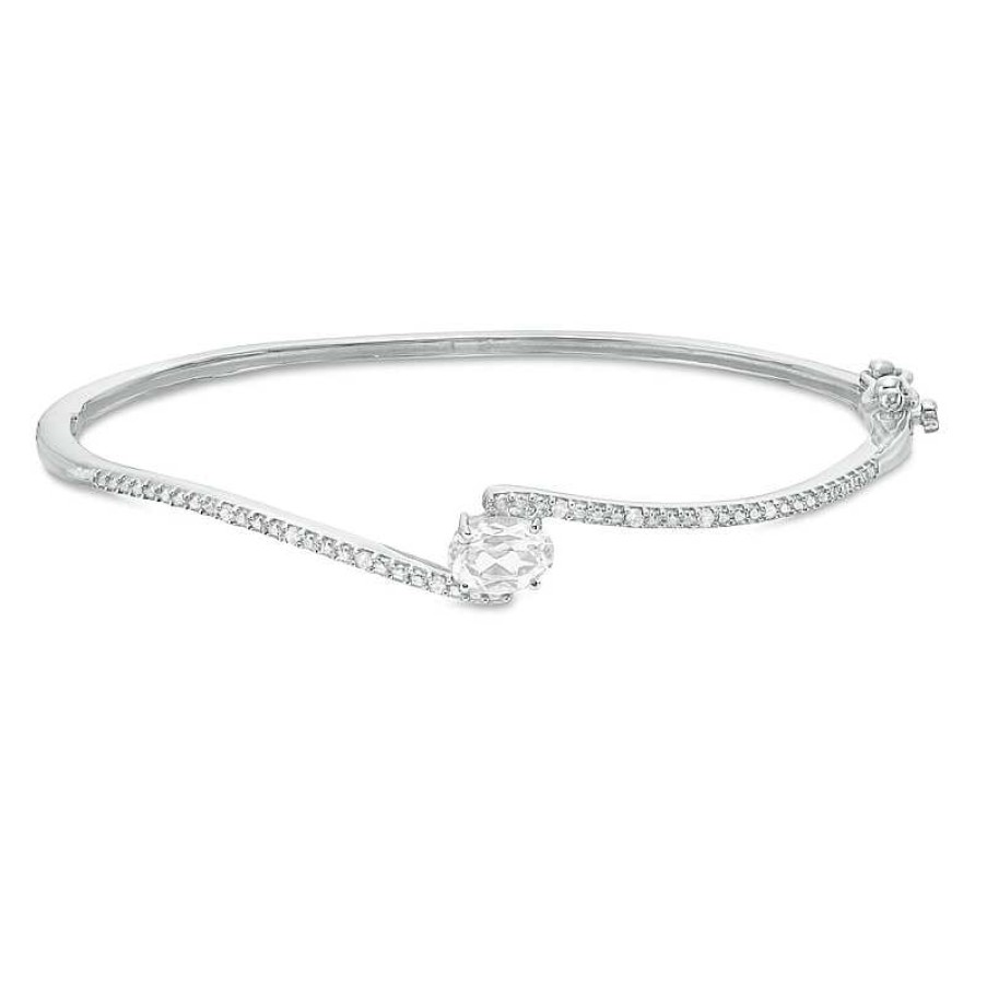 Zales Sideways Oval Lab-Created White Sapphire And 1/20 Ct. T.W. Diamond Bypass Bangle In Sterling Silver Bracelets