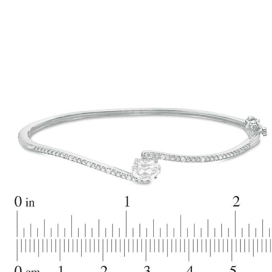 Zales Sideways Oval Lab-Created White Sapphire And 1/20 Ct. T.W. Diamond Bypass Bangle In Sterling Silver Bracelets